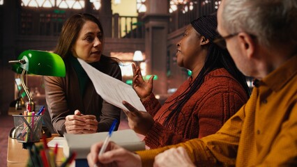 Diverse actors practicing theatre script with deep dedication in a library, rehearsal session highlights acting skills. Dramatic arts passion and cultural expression of theatrical play.
