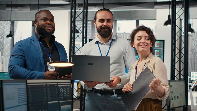 Diverse group of employees collaborate on project planning and analysis, using data from charts on tablet to drive performance metrics. Fostering teamwork and a workplace alliance.