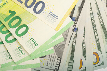 Collection of euro and dollar banknotes scattered on a flat surface