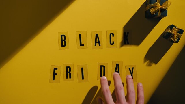 Black Friday on a yellow background with freebies during the discount party