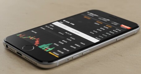 Smartphone displaying financial data and charts, illustrating trading and investment. - Powered by Adobe