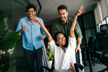 Joyful, excited diverse entrepreneurs are celebrating their success and the great work environment