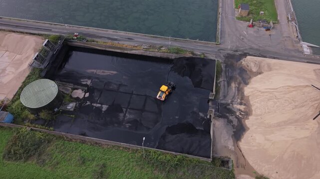 Machinery Cleans Water in a Large Industrial Settling Pool During the Day