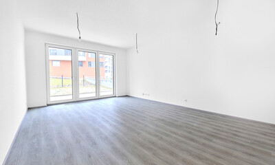 Spacious empty room with large windows and natural light, ideal for interior design mock up