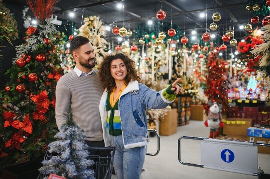 Young couple christmas shopping for holiday decorations - Powered by Adobe