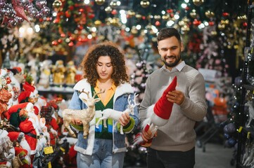 Couple choosing christmas decorations in store