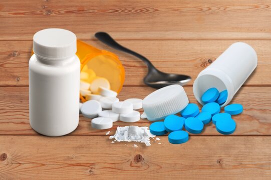 Medicines, supplements and drugs in a bottle with spoon