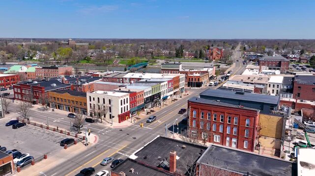 Martin Luther King bridge over River Raisin and Historic residential buildings aerial view on E Elm Avenue in historic downtown Monroe, Michigan MI, USA. 