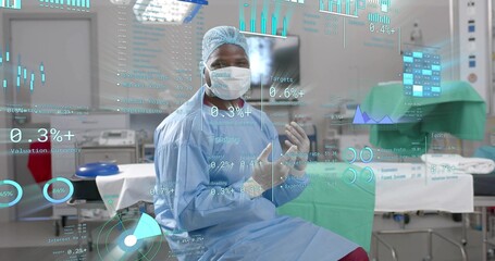 Analyzing surgeon wearing scrubs viewing holographic charts at hospital OR, with stainless trays