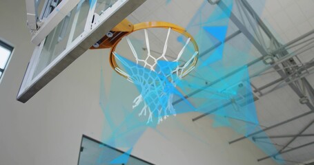 Capturing basketball hoop under gym truss ceiling, with clear backboard white nylon net and arm