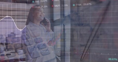 Talking woman in casual shirt using smartphone by desks at modern office, with stock graph overlay
