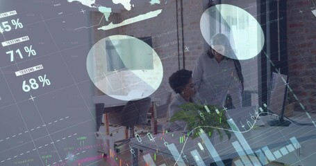 Collaborating two women in blazers analyzing data on monitors at office desk, with overlay charts