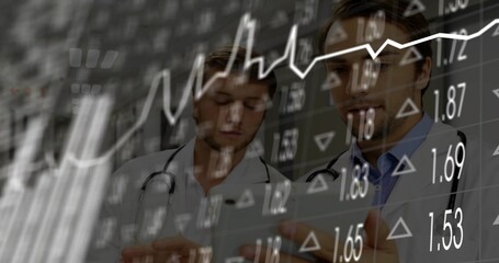 Reviewing tablet two doctors wearing lab coats, stethoscopes at hospital, with stock market overlay