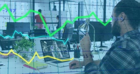 Adjusting lamp, worker in checked shirt calling colleague on laptop at open office with line graphs