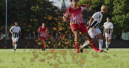 Red-and-white jersey soccer player kicking on grass field, with cleats, turf fragments spraying