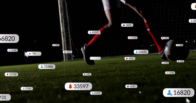 Dribbling soccer player's legs guiding ball on nightlit artificial turf, with goal net social icons