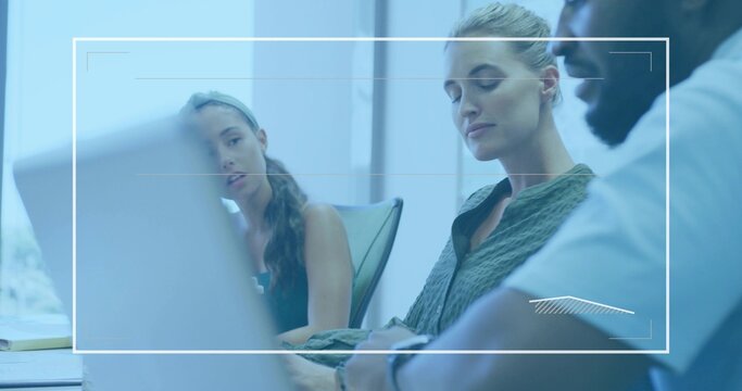 Collaborating colleagues in business attire discussing ideas in boardroom with laptop and notepad - Powered by Adobe