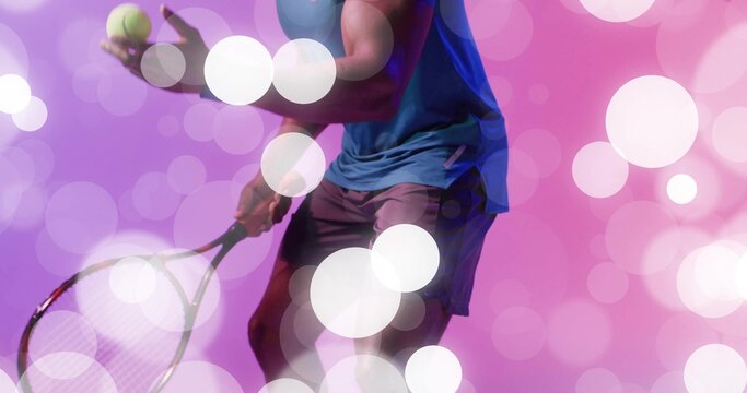 Poising African American tennis player wearing sportswear in studio with tennis racket and ball - Powered by Adobe