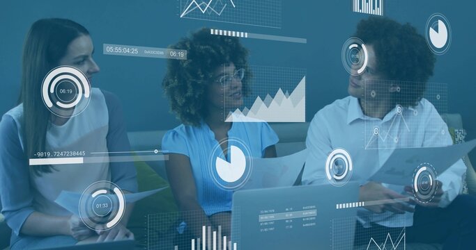 Reviewing reports, three professionals collaborating in office lounge with laptop, floating charts