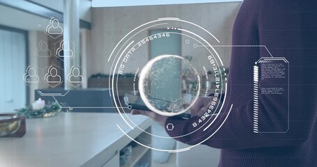 Tech pro unfolding tablet at kitchen island projecting AR data globe as two friends chatting behind - Powered by Adobe