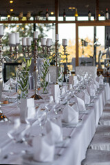 Elegant dining setup with candles and flowers for a special occasion in a modern restaurant