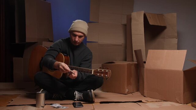 Homeless street musician collecting money for performance