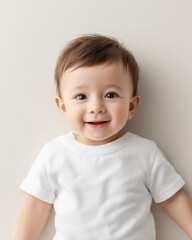Naklejka premium Adorable smiling baby in white t-shirt