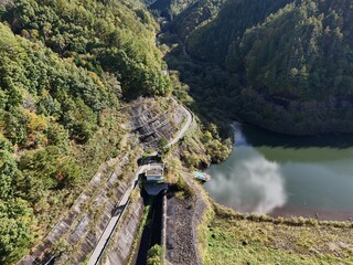 A mountain range with a river running through it. The river is calm and the water is clear. The...