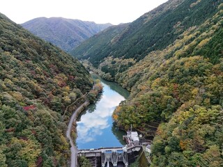 A beautiful mountain range with a river running through it. The river is surrounded by trees and...