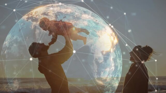 Father lifting son on shoreline, mother stepping forward passing child safely with tech globe