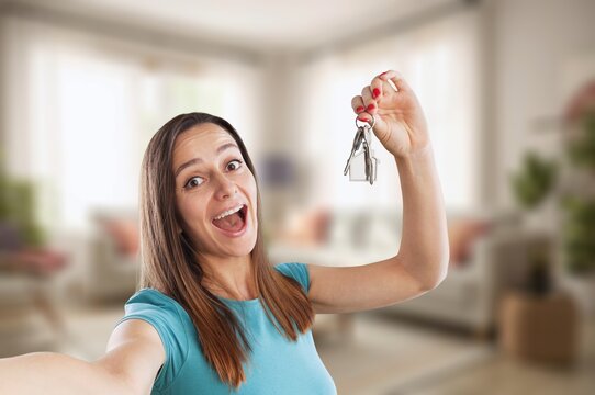 Real estate agent hold house key - Powered by Adobe