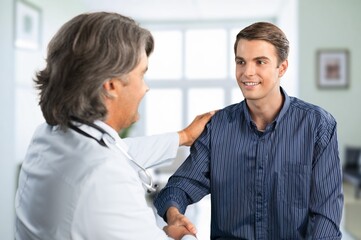 Doctor or nurse with  patient during visit to clinic.