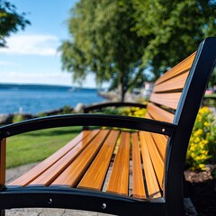 Park bench overlooks calm blue water and lush green trees.