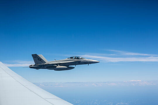 FA18 Super Hornet flying at altitude in close formation with another RAAF plane