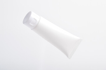 Blank packaging cosmetic plastic tube on white background