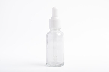 Clear glass dropper bottle on white background. Packaging mockup