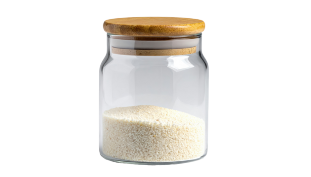 Clear jar with a wooden lid, containing a light-colored granular substance, isolated on a solid black background