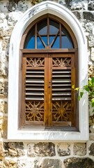 Fototapeta premium Ornate wooden window in stone wall