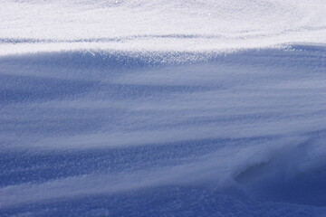 Snowdrift texture reveals nature's artistry in a serene winter landscape at dawn