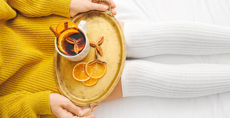 Woman drinking mulled wine at home