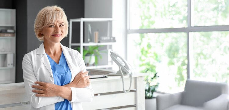 Portrait of female doctor near reception desk in clinic