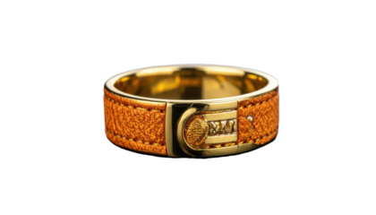 Gold ring featuring orange textured leather, gold clasp, and central numeric design against a stark black background