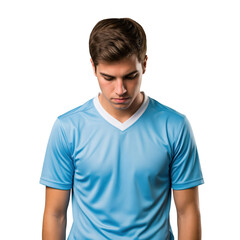 Obraz premium Young Caucasian man in light blue sports jersey looking down with a thoughtful expression, isolated studio shot