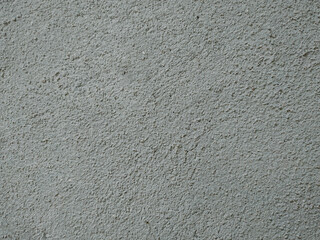 The image shows a wall with a textured finish, which can be referred to as a textured wall or a stucco finish