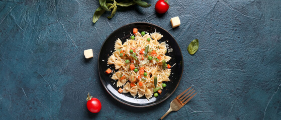 Plate with tasty pasta primavera on black background