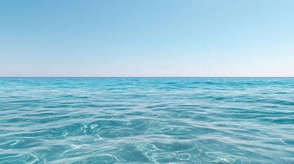 Clear ocean water reflects serene blue sky, creating tranquil atmosphere