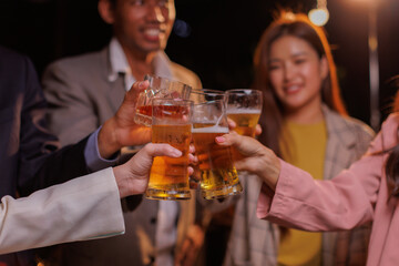 Happy Group of people Asian friends Drinking beer outdoors at the brewery for the New Year festival night time
people