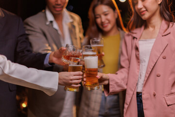 Happy Group of people Asian friends Drinking beer outdoors at the brewery for the New Year festival night time
people