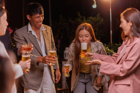 Happy Group of people Asian friends Drinking beer outdoors at the brewery for the New Year festival night time
people - Powered by Adobe