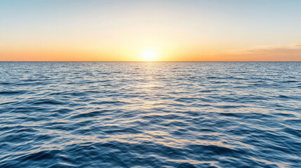 Obraz premium Sunrise over calm ocean waves creates serene and hopeful atmosphere